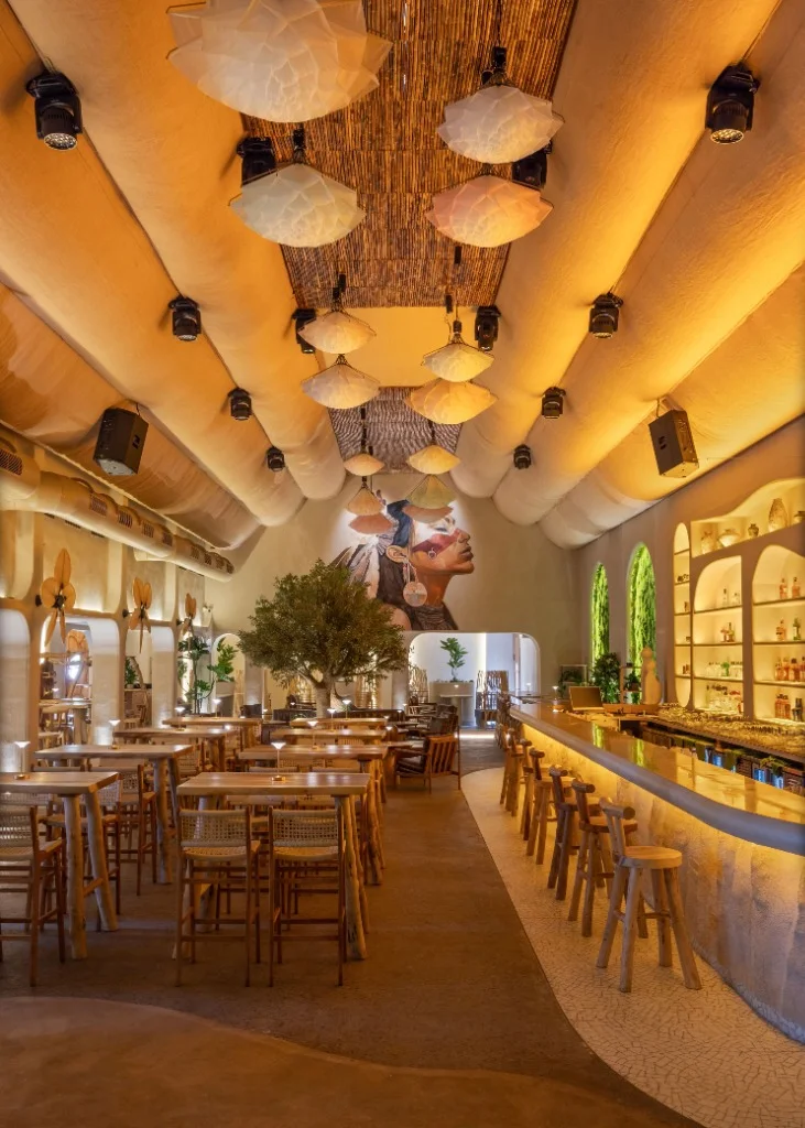 Warm hospitality interior with sculptural lighting and custom furniture